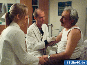 Lindenstraße: Vorsichtige Annäherung: Lisa (Sontje Peplow) hilft Carsten (Georg Uecker, Mi) bei der Behandlung von Murats Vater Muzaffer (Cetin Ipekkaya).